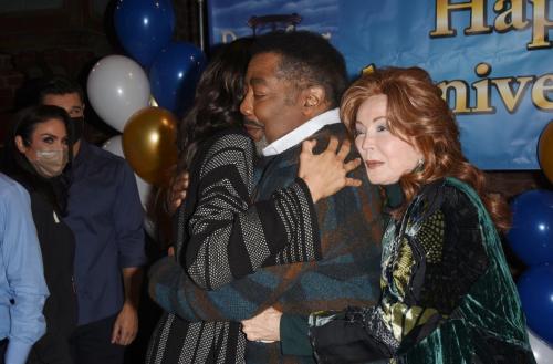Suzanne Rogers cuddles up to Jim on his big day along with Sal Stowers.
